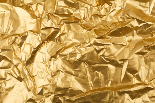 Golden crumpled wrapping paper background with space for text - Zdjęcie, obraz