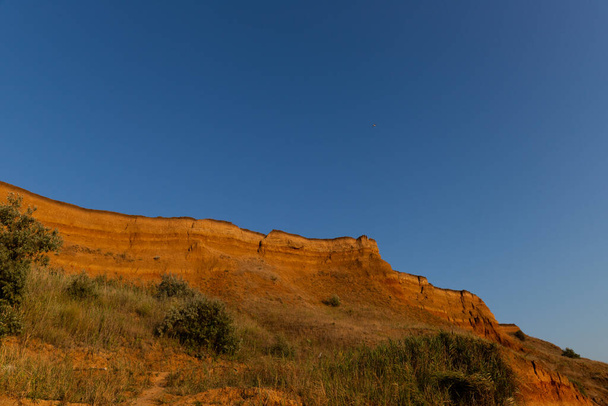 Beautiful landscape, sandy cliff over the sea. Travel concept. Beautiful nature texture - Valokuva, kuva