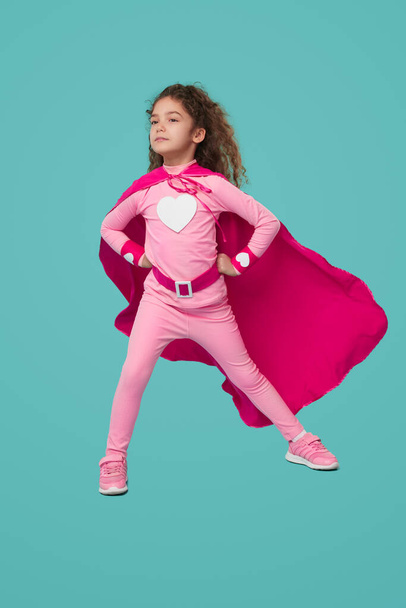 Fearless superhero girl in pink costume - Fotó, kép