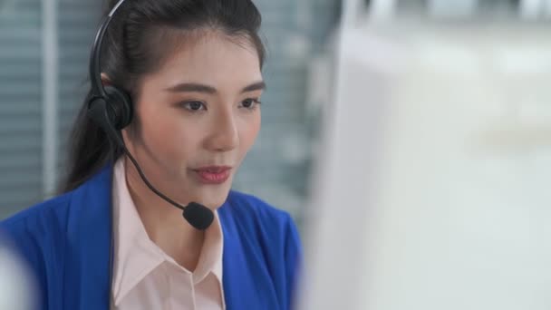 Business people wearing headset working actively in office - Felvétel, videó