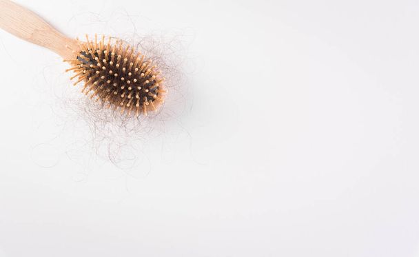 Healthcare problem concept. Hair loss or hair fall in comb on white background. - Photo, Image