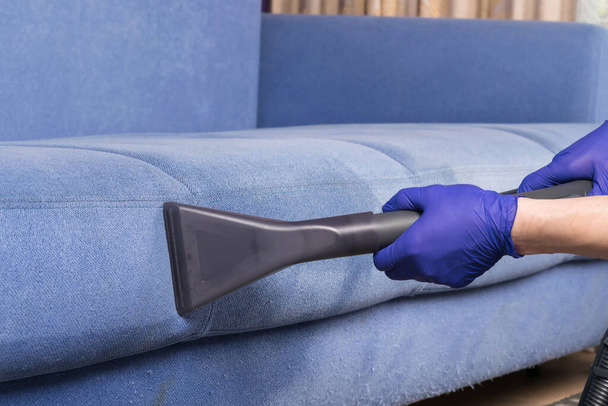 cleaning dirty blue sofa with washing vacuum cleaner, close-up - Photo, Image