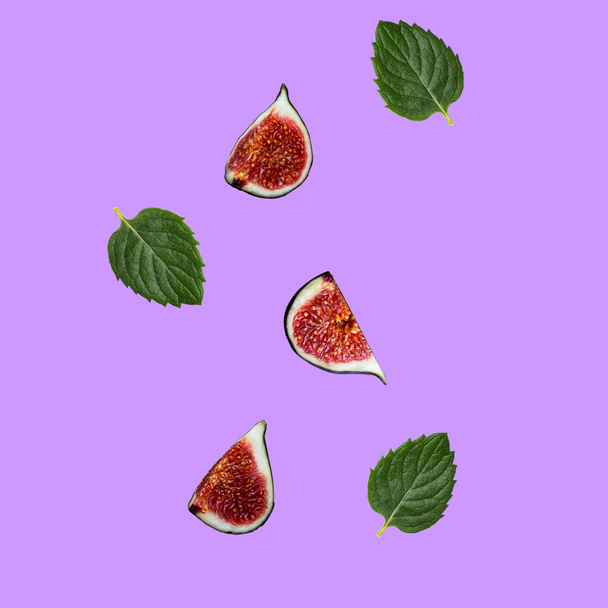 Sliced fig slices and mint leaves hang in the air - Фото, зображення