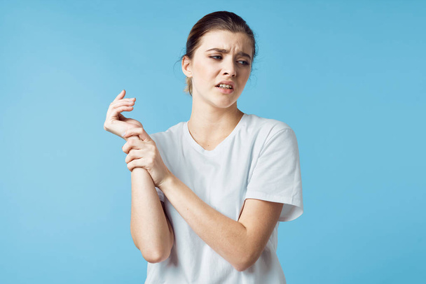 disgruntled woman in white t-shirt body pain health problems medicine - Valokuva, kuva