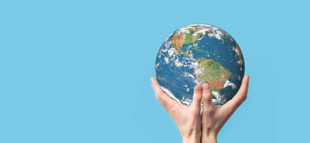 3D Earth planet globe in man, woman hand, hands on blue background. Environmental protection concept. Elements of this image furnished by NASA. - Photo, Image