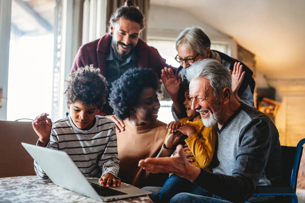 Portrait of a happy multigenerational multiethnic family at home. People group technology love concept - Fotoğraf, Görsel