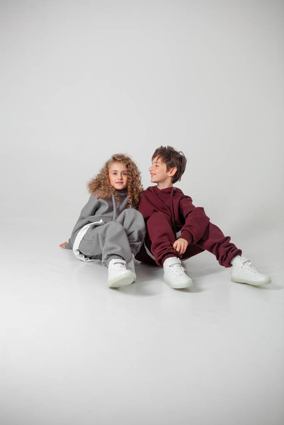 long-haired girl and boy in tracksuits - Photo, image