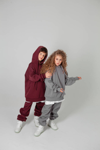 long-haired girl and boy in tracksuits - Valokuva, kuva