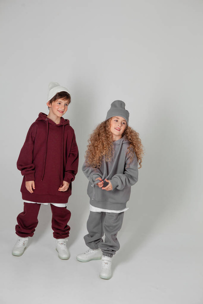 long-haired girl and boy in tracksuits - Foto, Imagem