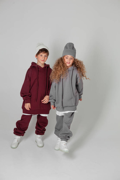 long-haired girl and boy in tracksuits - Foto, immagini