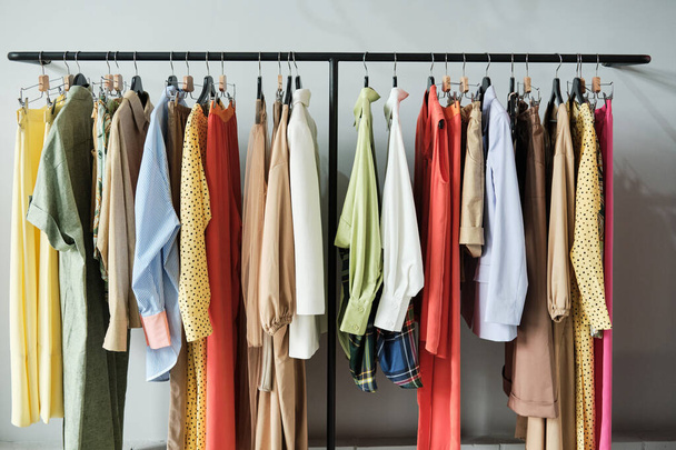 New clothes hanging on the rack in showroom - Photo, Image
