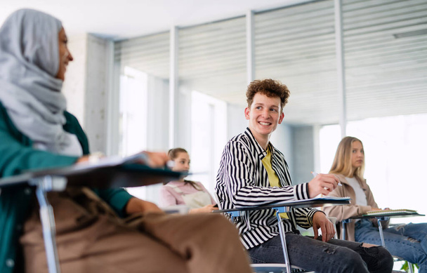 Portrait of university student sitting in classroom indoors, studying. - Fotografie, Obrázek