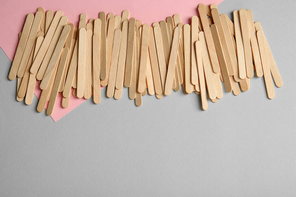 Pile of spatulas on color background, flat lay. Space for text - Photo, Image