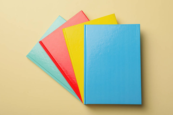 New colorful planners on beige background, top view - Foto, afbeelding