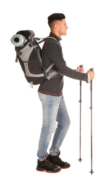Male hiker with backpack and trekking poles on white background - Foto, Imagen