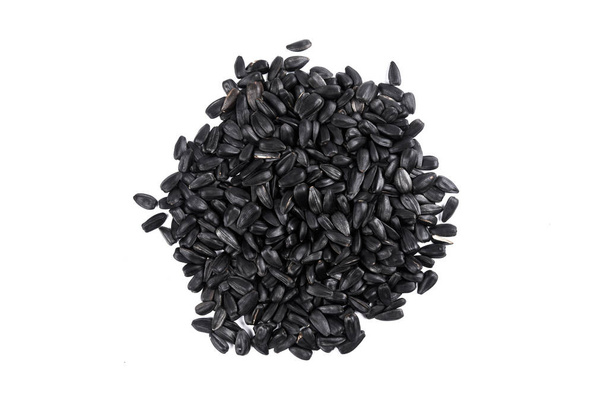 Heap of black sunflower seeds close-up on a white background with copy space - Foto, Bild