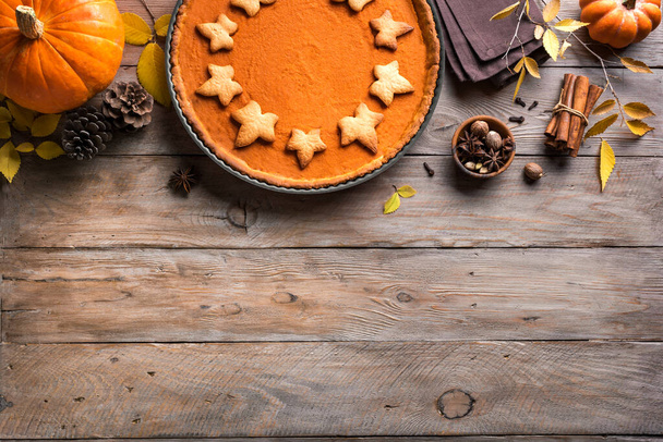 Pumpkin Pie on wooden background, top view, copy space. Homemade pastry for Thanksgiving holiday - traditional autumn  Pumpkin Pie or tart. - Fotografie, Obrázek