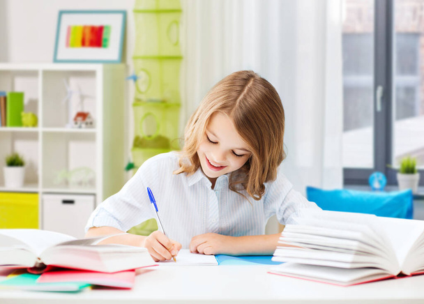happy smiling school girl with notebook and pen - Foto, Imagem
