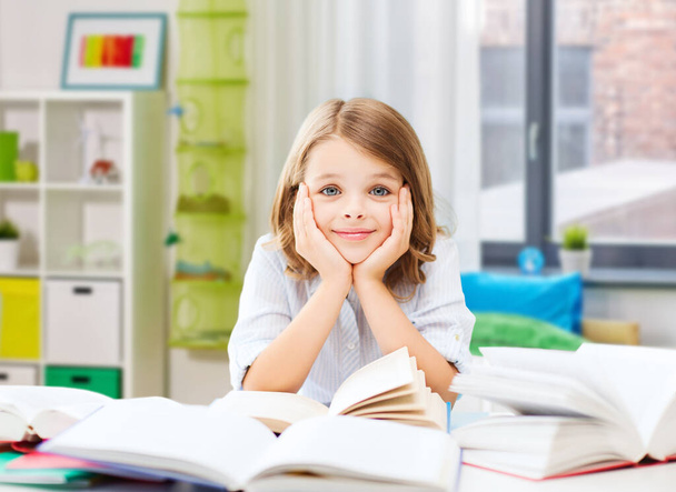 smiling student girl reading book at home - Foto, Imagem