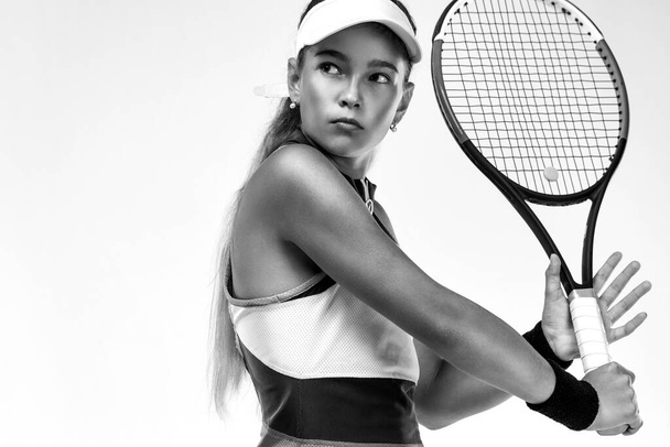 Tennis player. Beautiful girl teenager and athlete with racket in pink sporswear and hat on tennis court. Sport concept. - Photo, Image