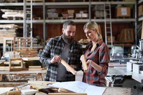 Two carpenters man and woman talking about design of products. Small business concept. - Fotoğraf, Görsel