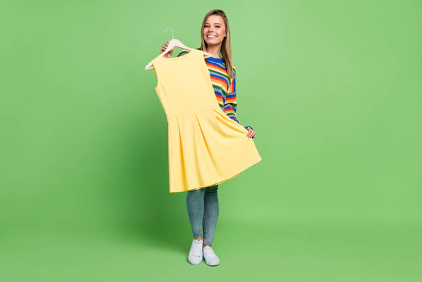Full length body size photo girl choosing dress in shopping center isolated on pastel green color background - Fotografie, Obrázek