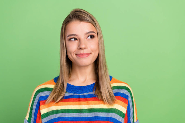 Photo portrait pretty girl curious dreamy in sweater looking blank space happy isolated pastel green color background - Foto, imagen