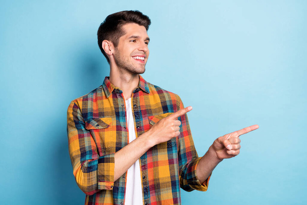 Portrait of attractive cheerful guy demonstrating copy blank space idea decision isolated over bright blue color background - Fotografie, Obrázek