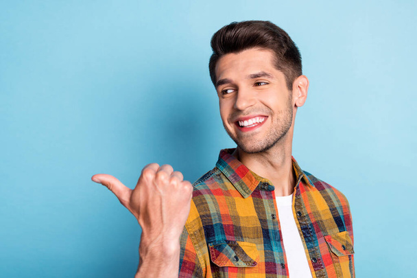 Portrait of attractive cheerful guy demonstrating copy blank empty space ad isolated over bright blue color background - Zdjęcie, obraz