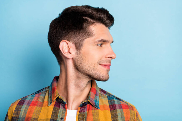 Portrait of attractive cheery well-groomed brunette guy wearing checked shirt looking aside isolated over bright blue color background - Photo, Image