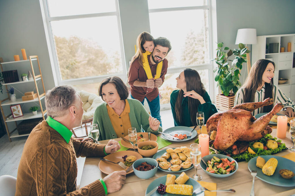 Portrait of attractive careful cheerful big full family eating festal turkey dish meal talking speaking having fun at home indoors - Zdjęcie, obraz