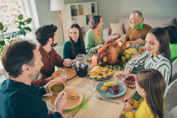 Photo of pretty charming family celebrating thanks giving day sitting table talking smiling indoors room home - Фото, зображення