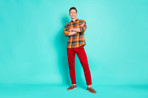 Full body photo of nice brunet young guy crossed arms wear shirt trousers sneakers isolated on teal background - Foto, immagini
