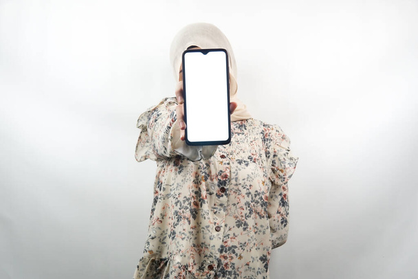 Muslimka s rukama drží smartphone, propagace aplikace, propagace něco, izolované na bílém pozadí, reklamní koncept - Fotografie, Obrázek