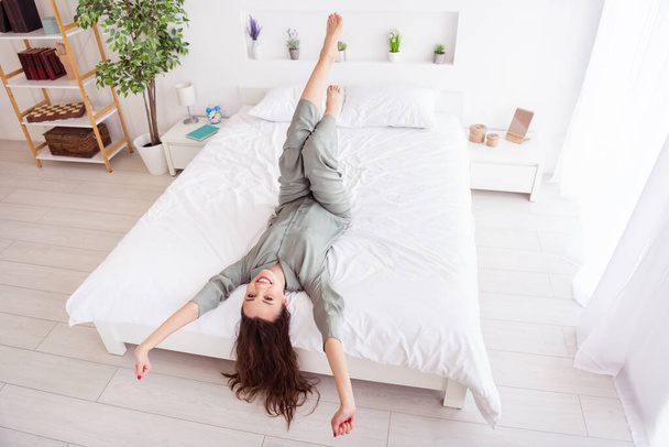 Top above high angle view portrait of attractive cheerful girl lying on bed stretching good mood at home house light white interior - Fotoğraf, Görsel
