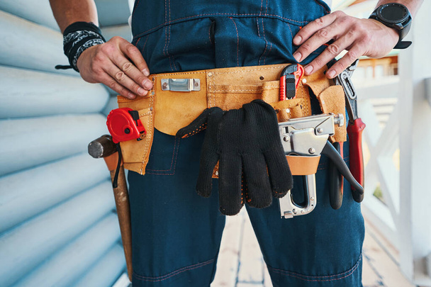 Tool holder belt around male person waist - Фото, изображение