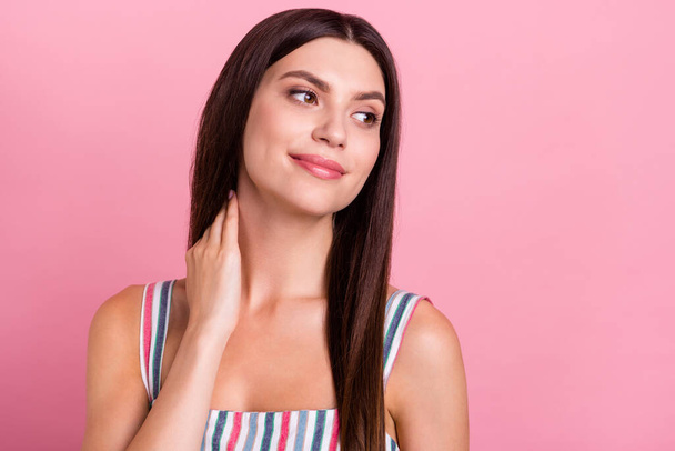 Photo of young attractive woman happy positive smile hand touch neck bodycare look empty space isolated over pastel color background - Zdjęcie, obraz