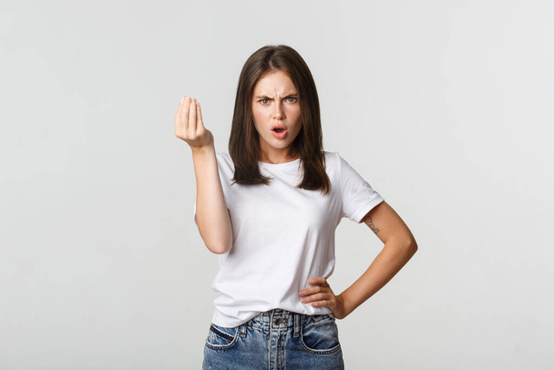 Confused and angry brunette girl arguing about money - Fotó, kép