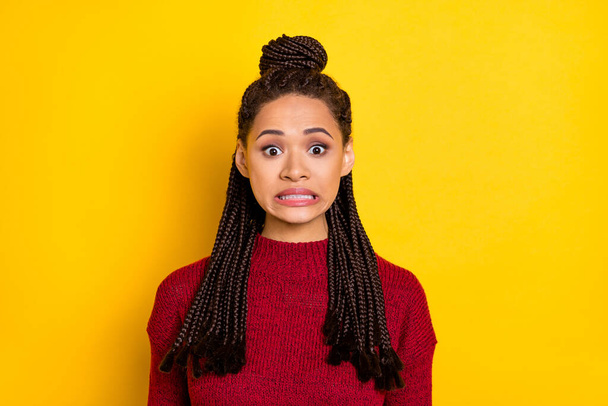 Photo of shocked unhappy dark skin woman dressed red sweater big eyes isolated yellow color background - Фото, изображение