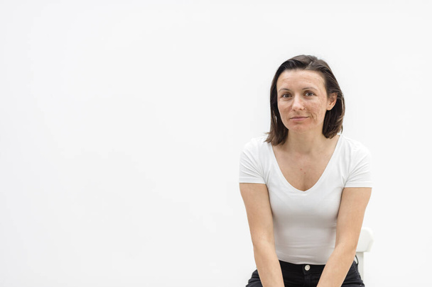 Photo of woman looking at camera on white background. - Zdjęcie, obraz