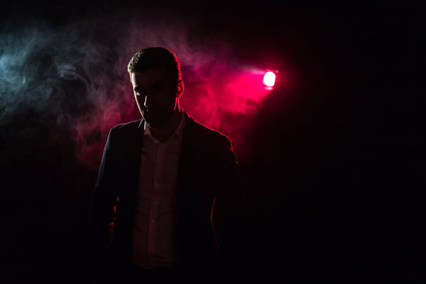 Photo of standing man and pink light on the background. - Fotografie, Obrázek