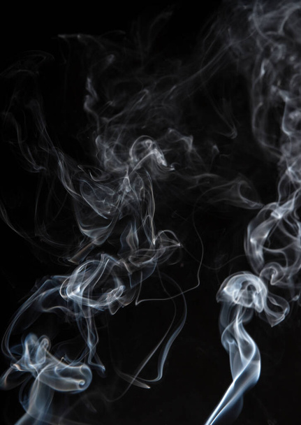 Abstract puffs of smoke on a black background. - Photo, Image