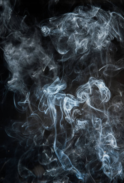 Abstract puffs of smoke on a black background. - Foto, immagini