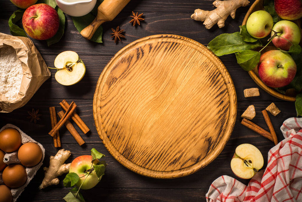 Apple pie with ginger and cinnamon at dark wooden table. - Φωτογραφία, εικόνα