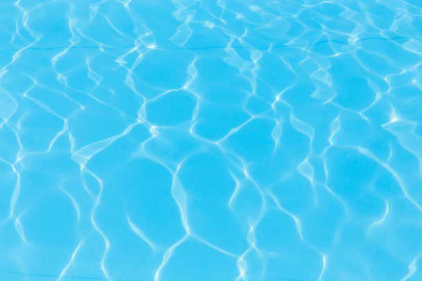 Blue pool water with sun reflections background - Photo, Image