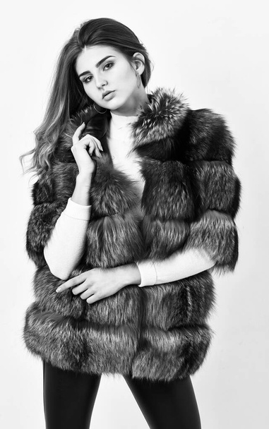 Fur store model posing in soft fluffy warm coat. Pretty fashionista. Fur fashion concept. Woman makeup and hairstyle posing mink or sable fur coat. Winter elite luxury clothes. Female brown fur coat - Fotó, kép