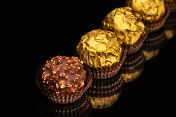 chocolate candies on black background - Zdjęcie, obraz