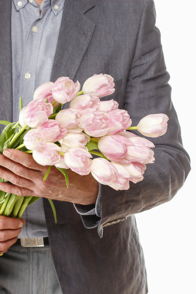 Man holding bouquet of pink tulips - Foto, Imagen