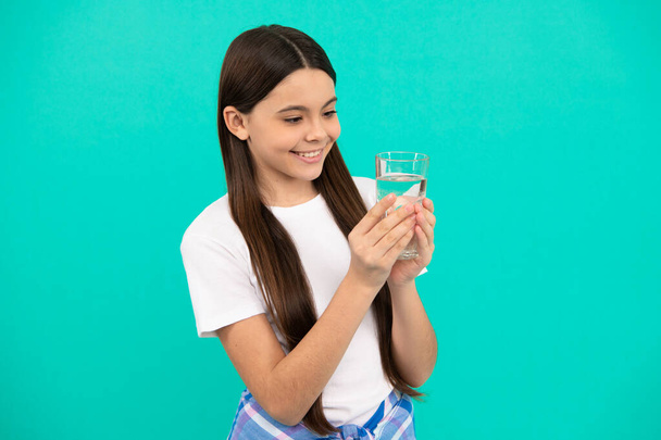 happy kid going to drink glass of water to stay hydrated and keep daily water balance, hydration. - Photo, Image