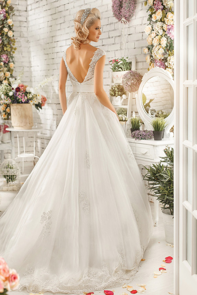 The beautiful  woman posing in a wedding dress - Photo, Image
